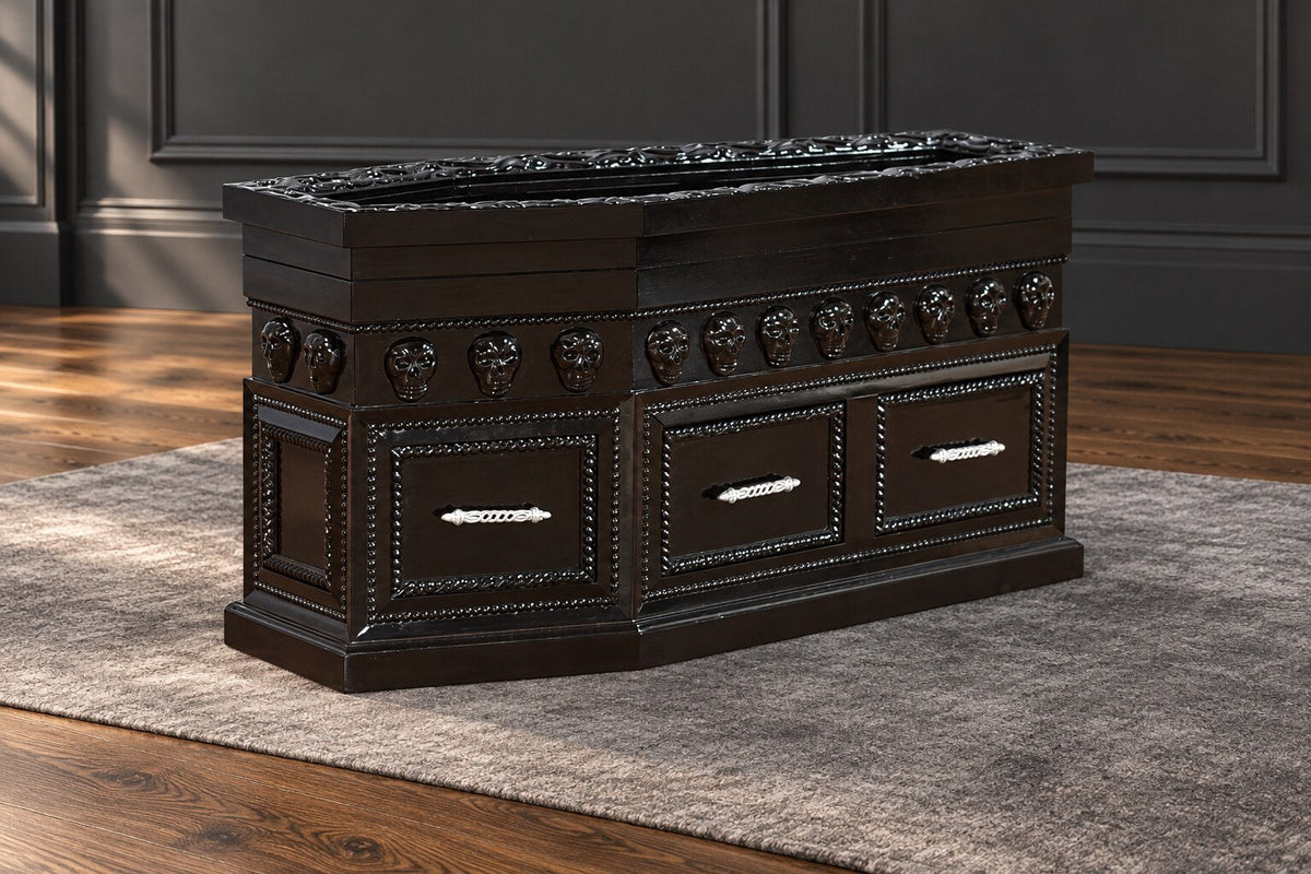 Haunt Crypt Keeper Coffin Coffee Table with skull detailing, three drawer fronts and a shaped plinth base