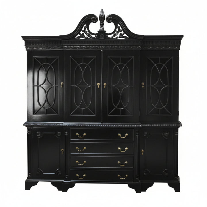 The Maleficent Bookcase, a handcrafted timber bookcase with glazed upper doors, central drawers, lower cupboards and a shaped pediment.