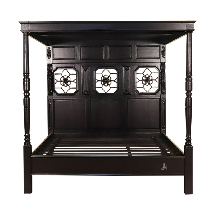 Side view of the Alchemist Bed showing the substantial timber frame, high headboard and grounded footboard structure