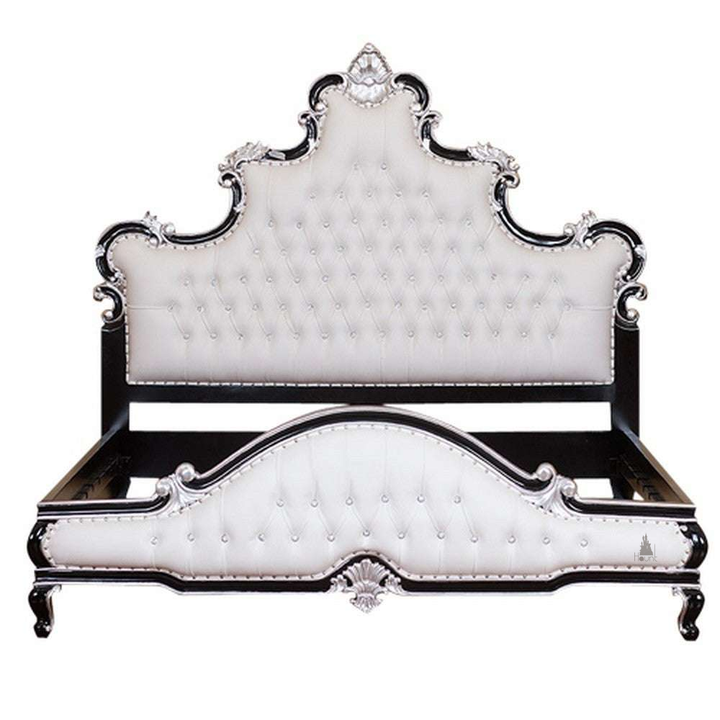 Aphrodite Bed shown at an angle with carved gothic headboard, upholstered detailing and sculptural footboard