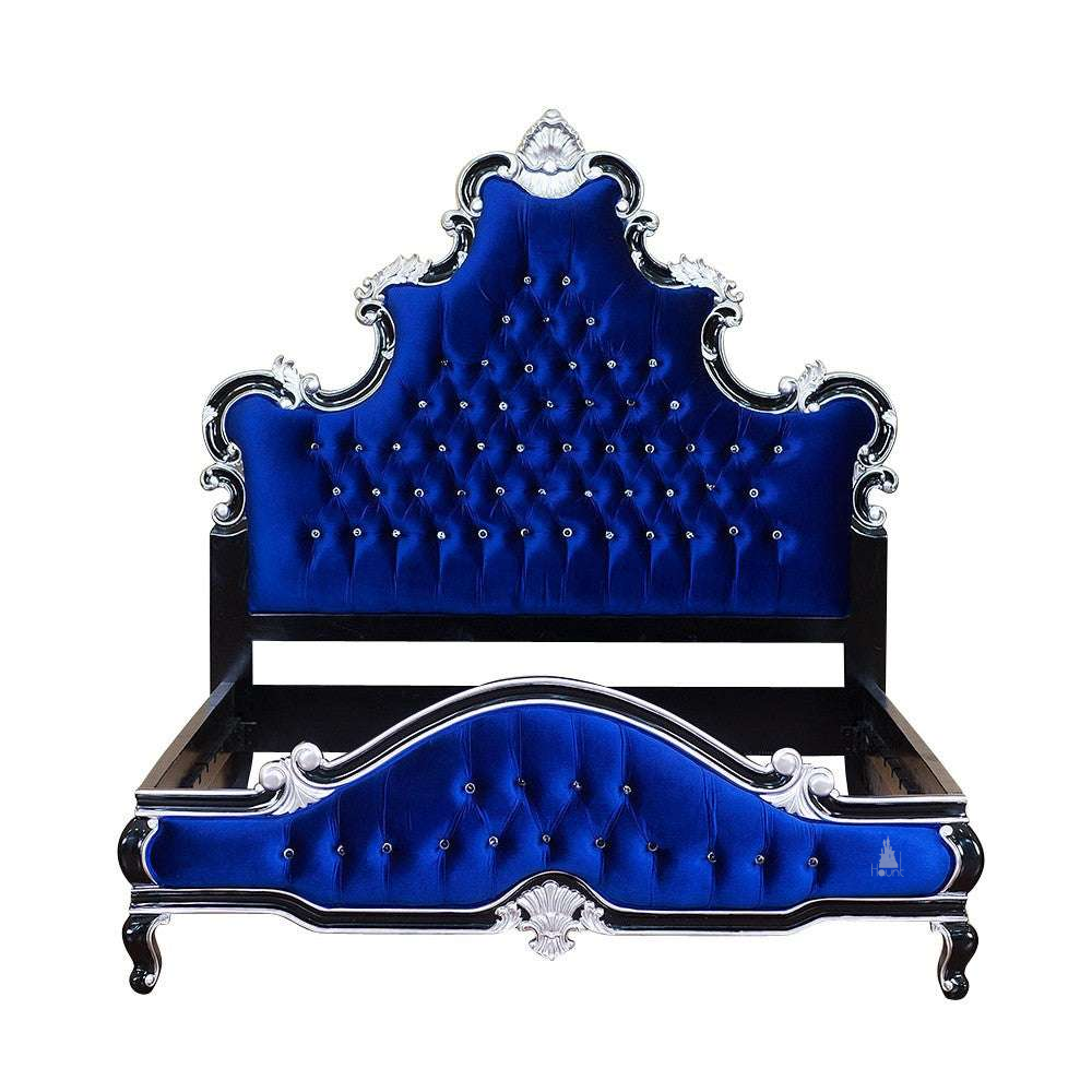 Close-up of the Aphrodite Bed showing carved crest detail, scrolling mahogany frame and upholstered headboard