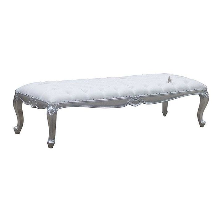 The Aphrodite Bench, a handcrafted upholstered bench with button tufting, carved apron detailing and curved legs.