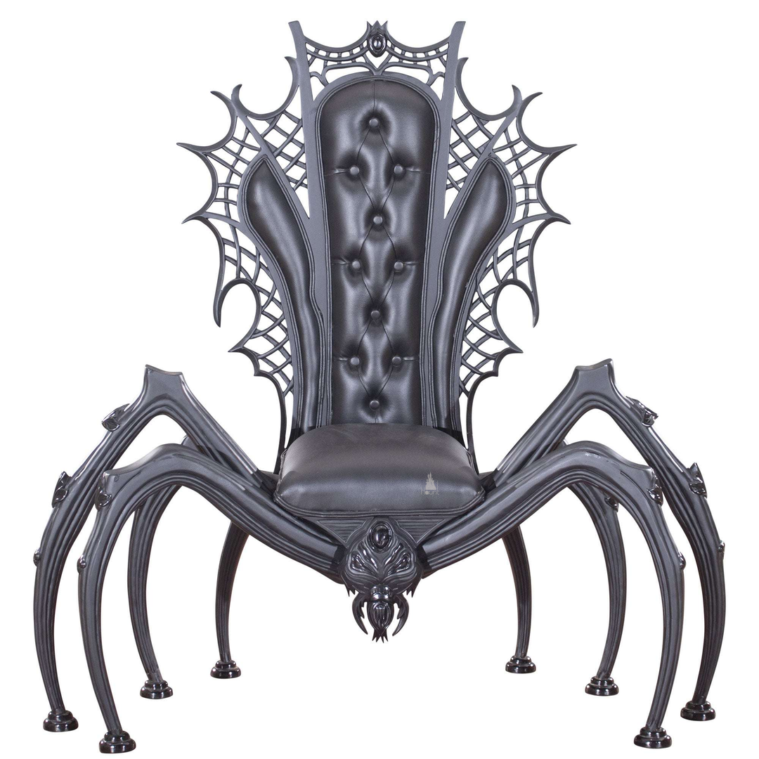 Black spider throne chair with a tufted back, carved spiderweb frame and eight sculpted legs.