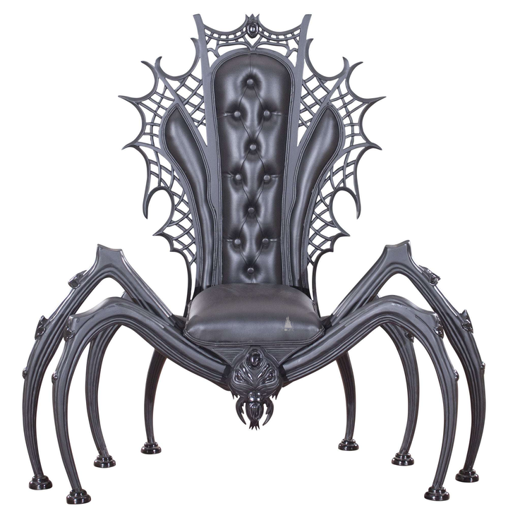 Black spider throne chair with a tufted back, carved spiderweb frame and eight sculpted legs.