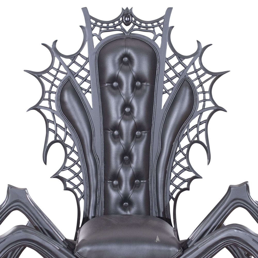 Close-up of the black spider throne chair's tufted back and carved spiderweb details.