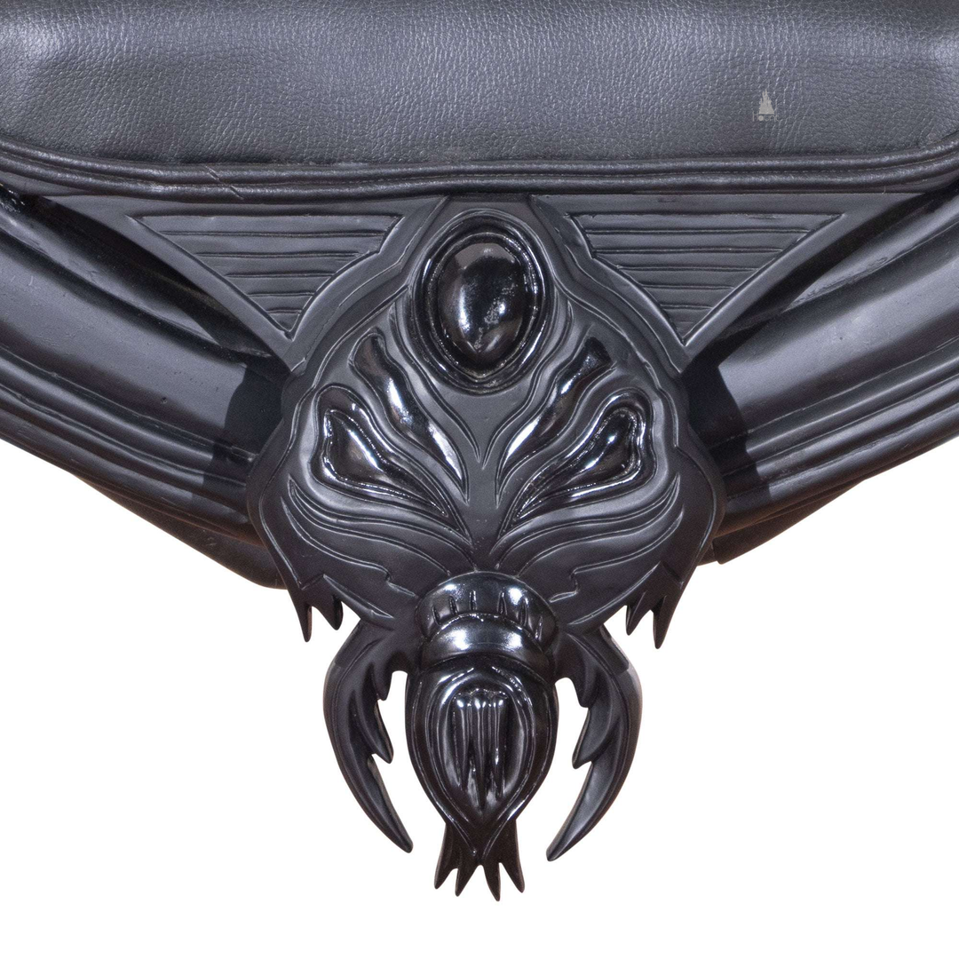 Another view of the Arachnid Throne, a black spider-inspired throne with a carved web back and sculpted legs