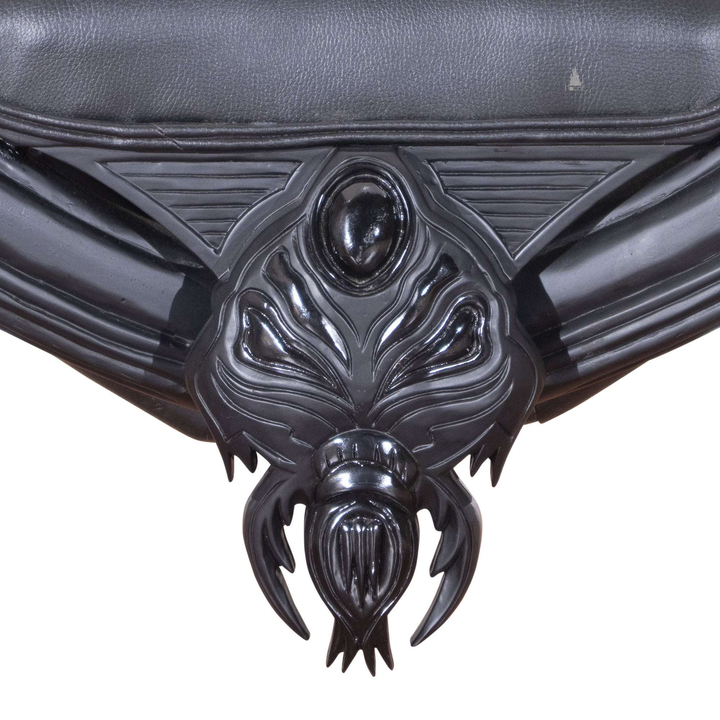 Another view of the Arachnid Throne, a black spider-inspired throne with a carved web back and sculpted legs