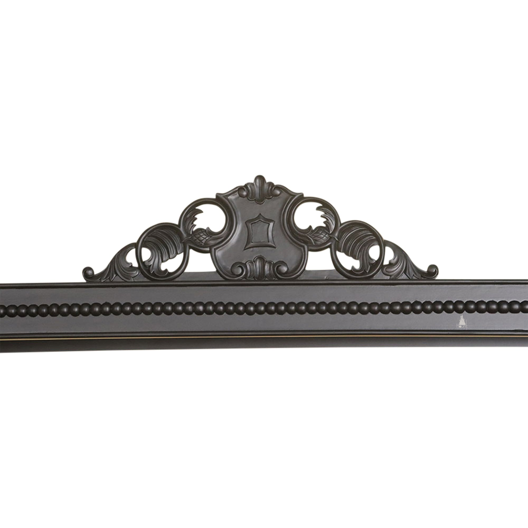 Detail view of the Aurora Bed showing ornate timber carving and semi-canopy bed construction