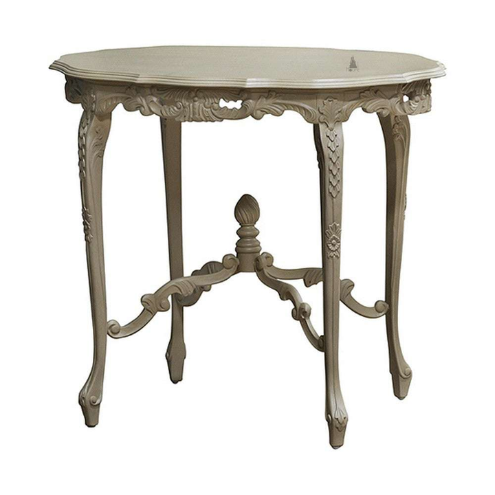 The Aurora Dining Table, a handcrafted ornate dining table with a rounded top, richly carved apron and stretcher base.