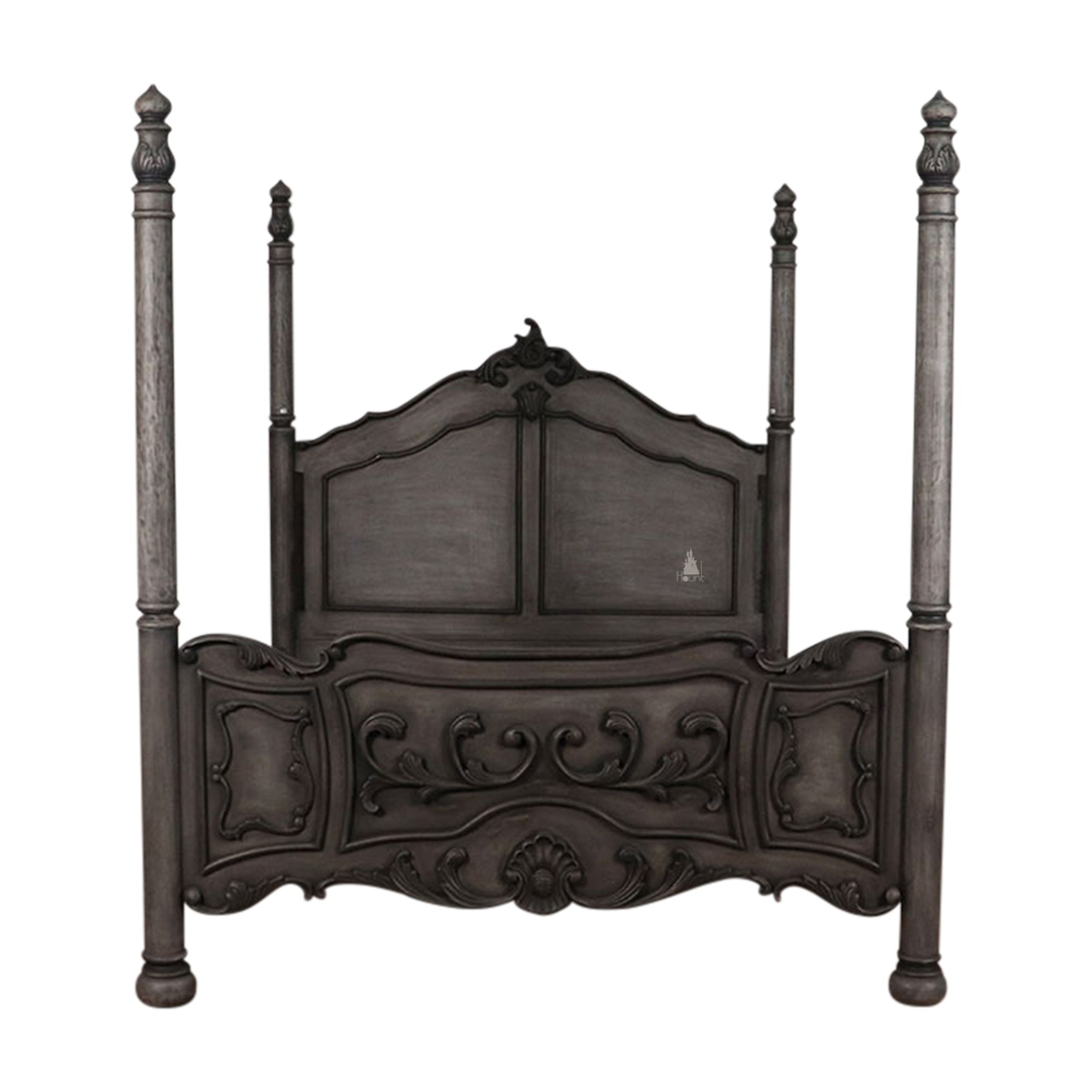 The Countess Bed, a handcrafted four poster bed with slender posts, a shaped panel headboard and an ornate scrolled footboard.