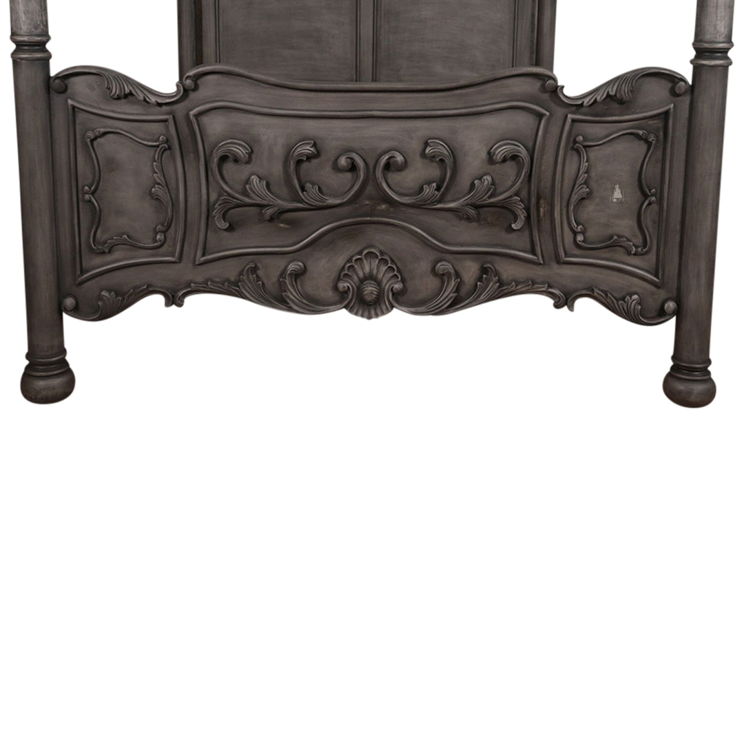 The Countess Bed, a handcrafted four poster bed with slender posts, a shaped panel headboard and an ornate scrolled footboard.