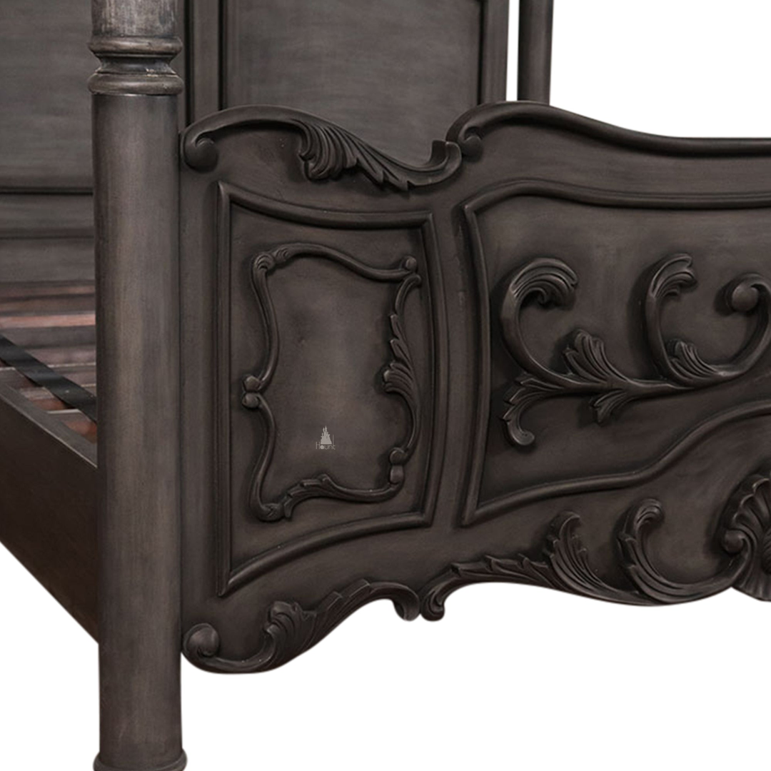 The Countess Bed, a handcrafted four poster bed with slender posts, a shaped panel headboard and an ornate scrolled footboard.