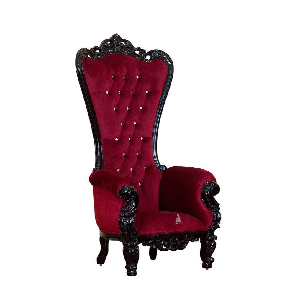 The Countess Throne, a handcrafted gothic throne chair with a tall button-tufted back, carved crest, rolled arms and ornate carved frame.