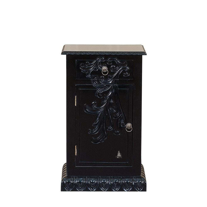 The Dark Desires Side Table, a handcrafted black gothic bedside cabinet with carved front detailing, ring-pull hardware and a heavy plinth base.