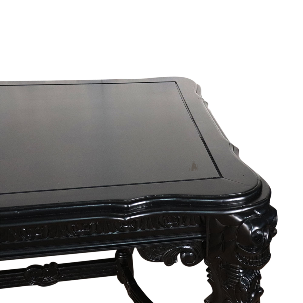 The Death Emperor Dining Table, a handcrafted black gothic dining table with carved legs, stretcher supports and skull detailing.