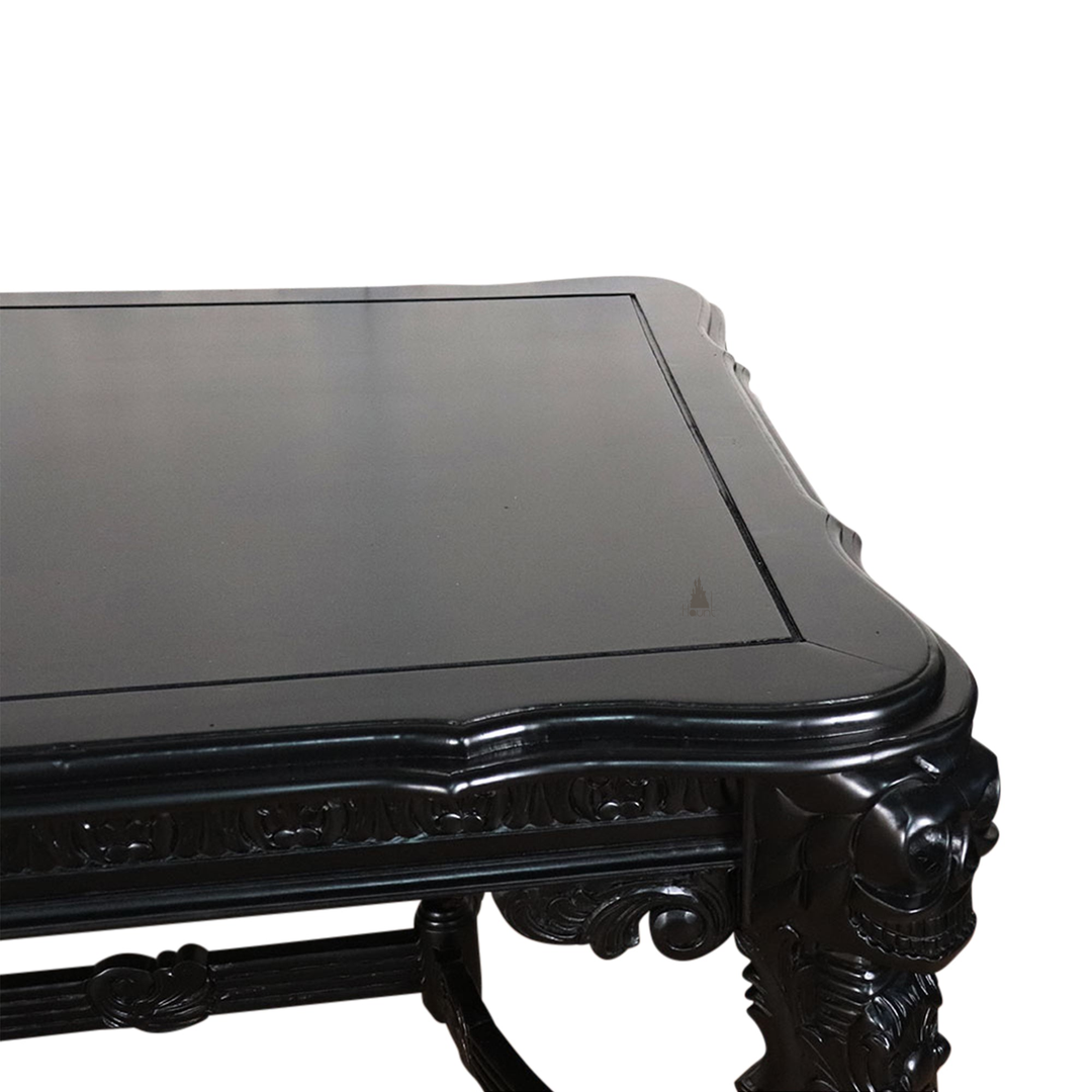 The Death Emperor Dining Table, a handcrafted black gothic dining table with carved legs, stretcher supports and skull detailing.