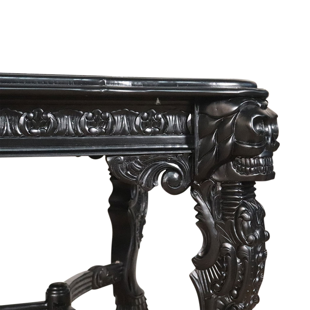 The Death Emperor Dining Table, a handcrafted black gothic dining table with carved legs, stretcher supports and skull detailing.