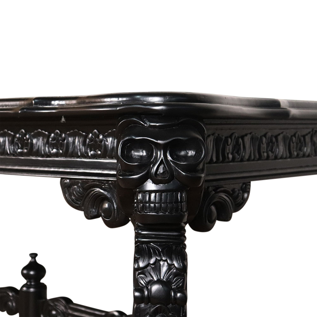 The Death Emperor Dining Table, a handcrafted black gothic dining table with carved legs, stretcher supports and skull detailing.