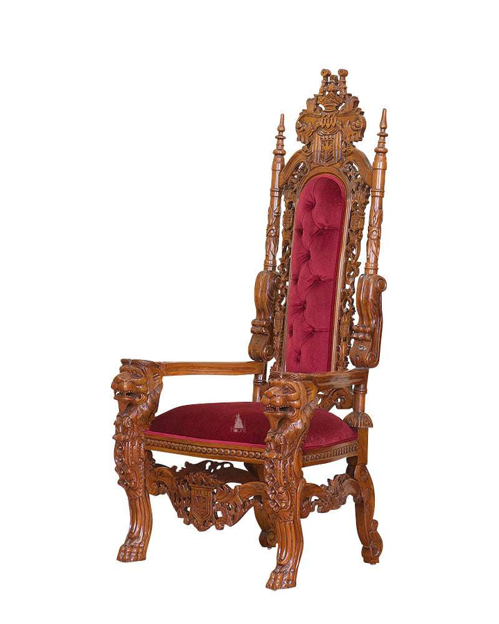 The Emperor Throne, a handcrafted gothic throne chair with a tall openwork back, crown-like cresting and upholstered back and seat panels.