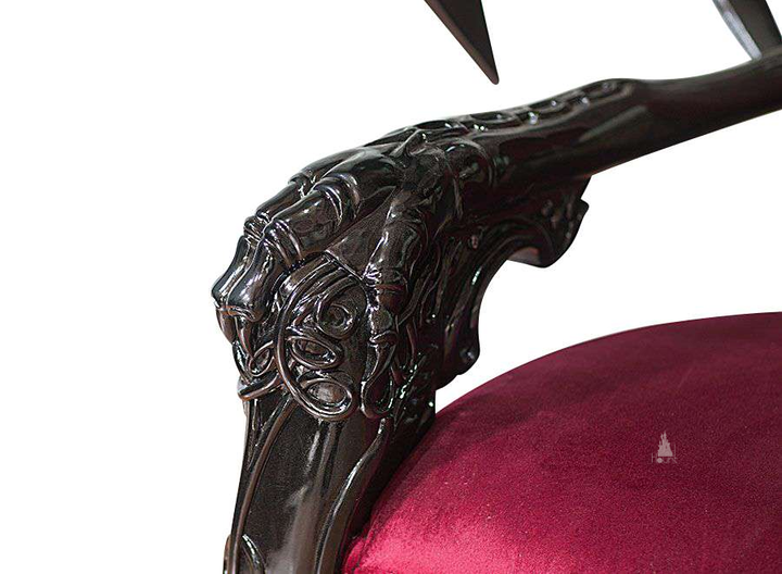 The House of Fire Throne, a handcrafted gothic throne chair with a bat-wing frame, horned carved crest and shield-shaped upholstered back.