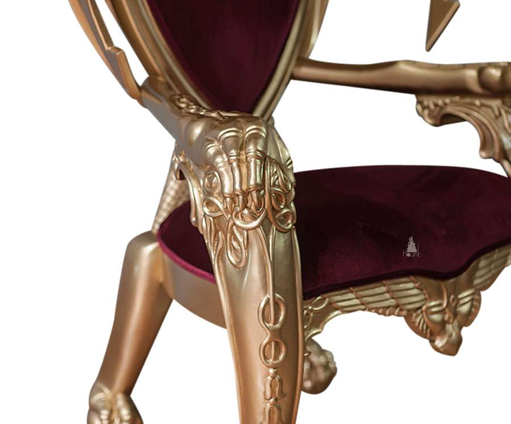 The House of Fire Throne, a handcrafted gothic throne chair with a bat-wing frame, horned carved crest and shield-shaped upholstered back.