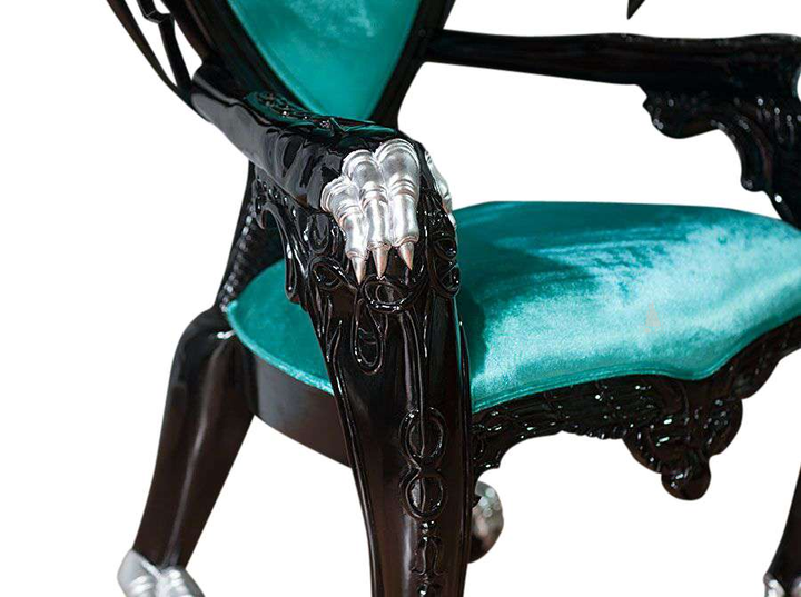 The House of Fire Throne, a handcrafted gothic throne chair with a bat-wing frame, horned carved crest and shield-shaped upholstered back.