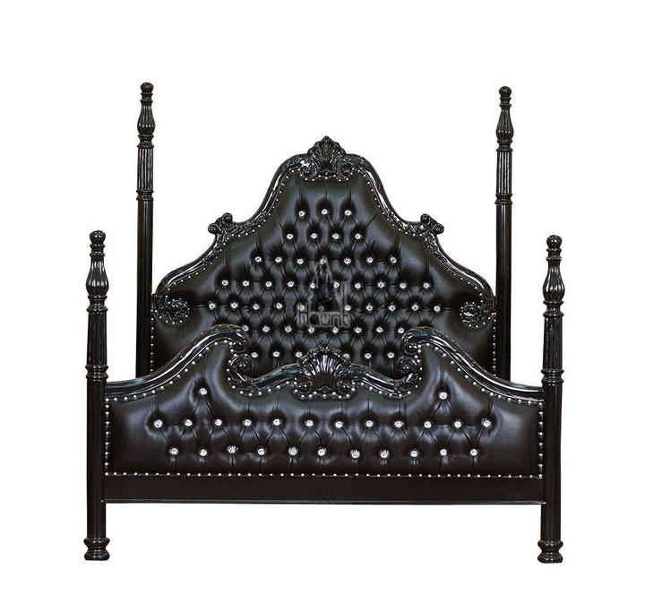 Front view of the Luxe Bed showing tall carved four poster posts, deep button-tufted upholstery and a hand-carved mahogany frame