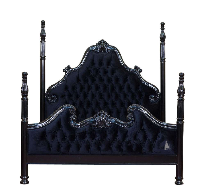 Detail view of the Luxe Bed showing carved mahogany frame and upholstered panel construction