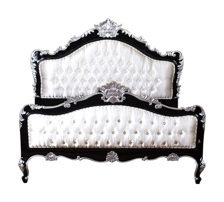 The Mafia Bed, a handcrafted upholstered statement bed with deep button tufting, serpentine lines and carved crest detailing.