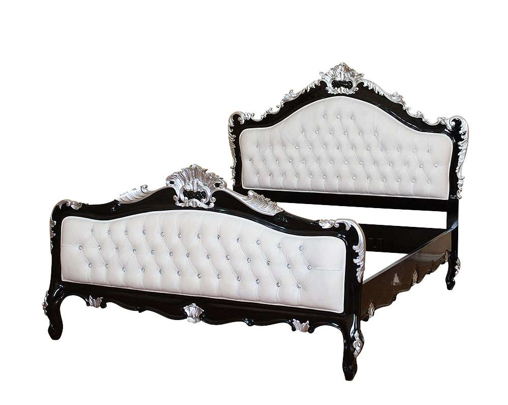 The Mafia Bed, a handcrafted upholstered statement bed with deep button tufting, serpentine lines and carved crest detailing.