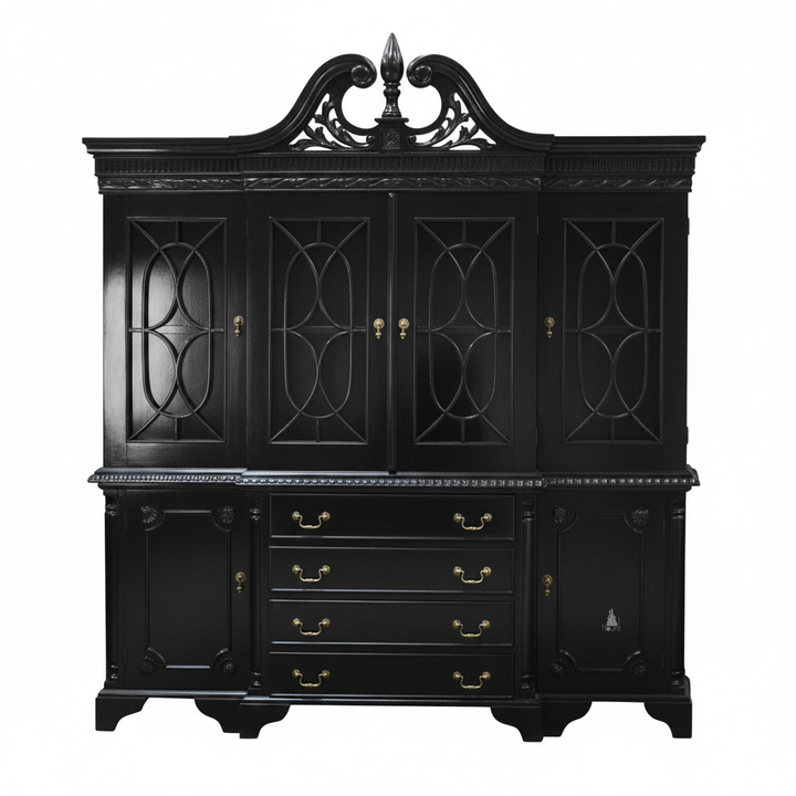 The Maleficent Bookcase, a handcrafted timber bookcase with glazed upper doors, central drawers, lower cupboards and a shaped pediment.