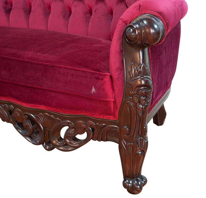 The Maleficent Lounge, a handcrafted gothic provincial sofa with deep button tufting, rolled arms and ornate carved timber frame.