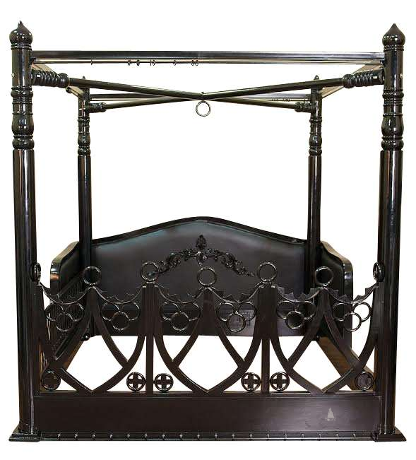The Obey Surrender BDSM Bed, a handcrafted BDSM-inspired four poster bed with metal frame, O-ring hardware and open restraint-inspired panels.