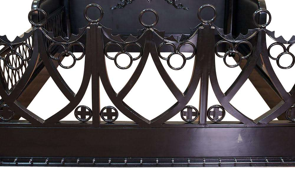 The Obey Surrender BDSM Bed, a handcrafted BDSM-inspired four poster bed with metal frame, O-ring hardware and open restraint-inspired panels.