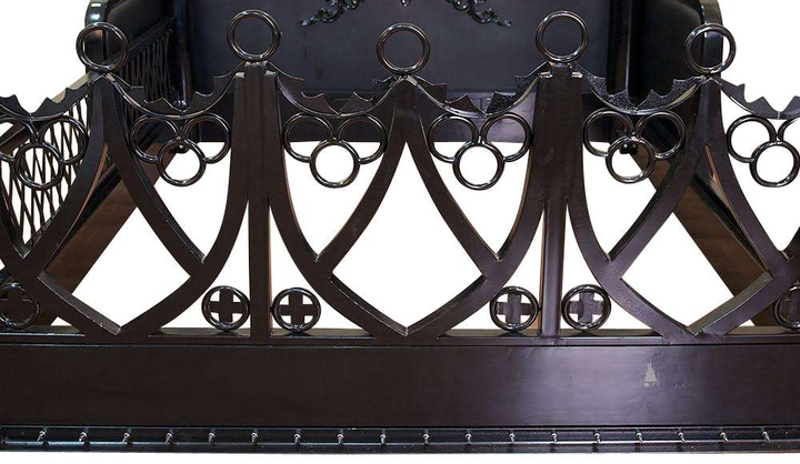 The Obey Surrender BDSM Bed, a handcrafted BDSM-inspired four poster bed with metal frame, O-ring hardware and open restraint-inspired panels.