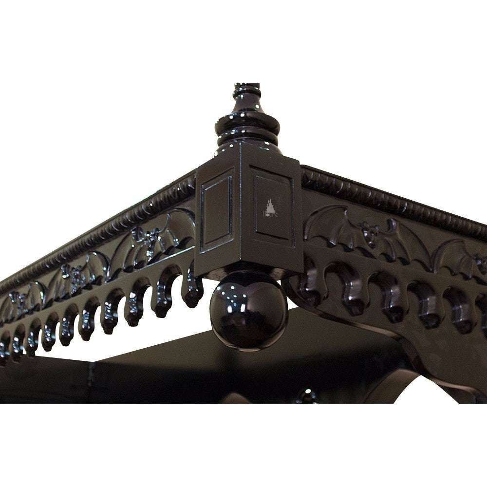 Top detail of the Queen of the Damned Cathedral Bed showing carved gothic cresting and architectural mahogany decoration