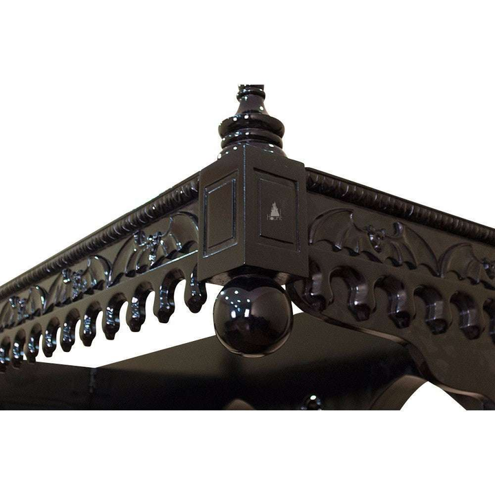 Top detail of the Queen of the Damned Cathedral Bed showing carved gothic cresting and architectural mahogany decoration