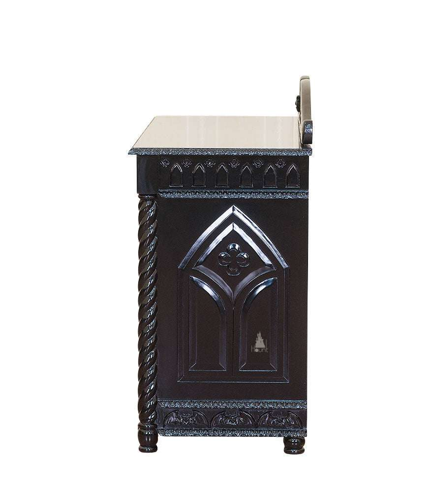 Another view of the Queen of the Damned Cathedral Dresser, a black chest of drawers crowned with a carved bat-wing crest