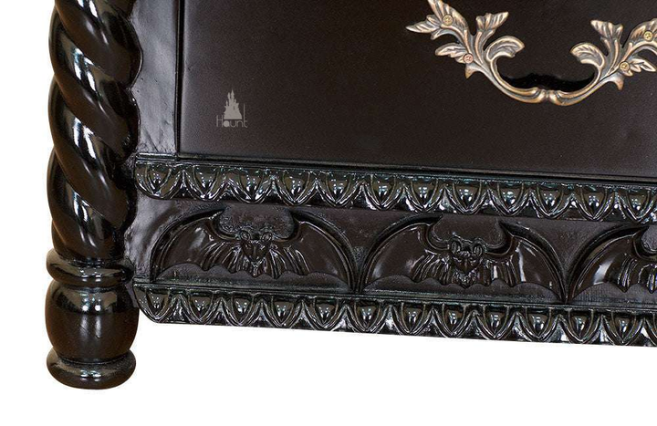 Another view of the Queen of the Damned Cathedral Dresser, a black chest of drawers crowned with a carved bat-wing crest