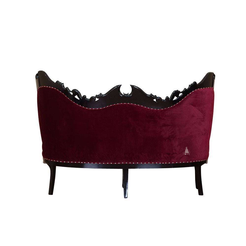Another view of the Queen of the Damned Love Seat, a dramatic two-seat gothic sofa with deep red upholstery