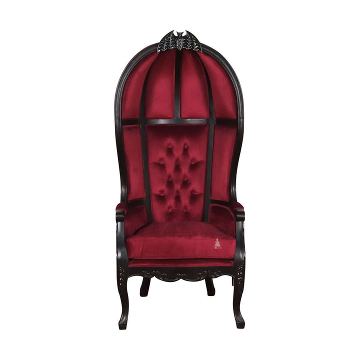 Queen of the Damned Porter Chair, a tall hooded chair with deep red tufted upholstery, black timber frame and a bat crest