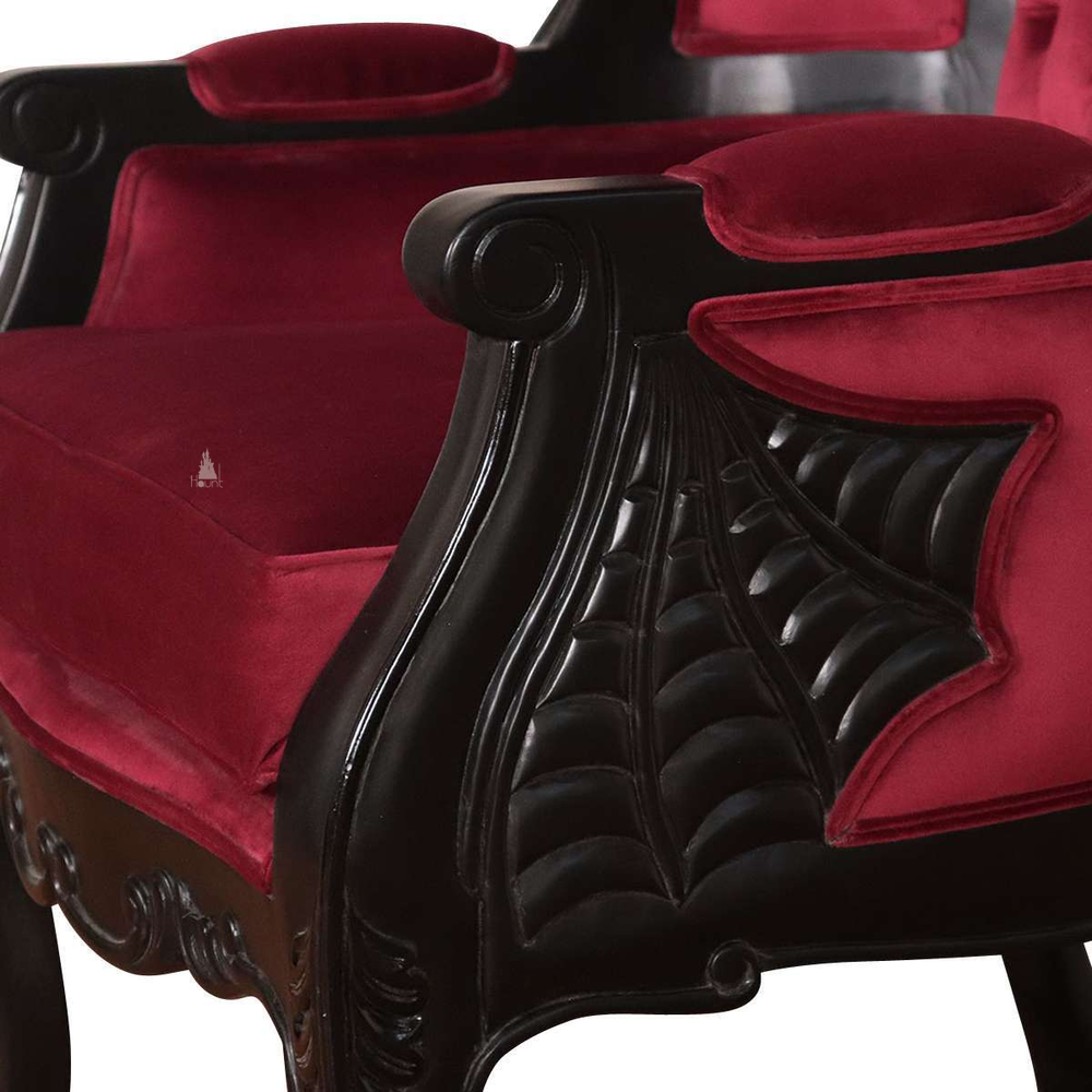 Another view of the Queen of the Damned Porter Chair, a tall hooded chair with deep red upholstery and a bat crest