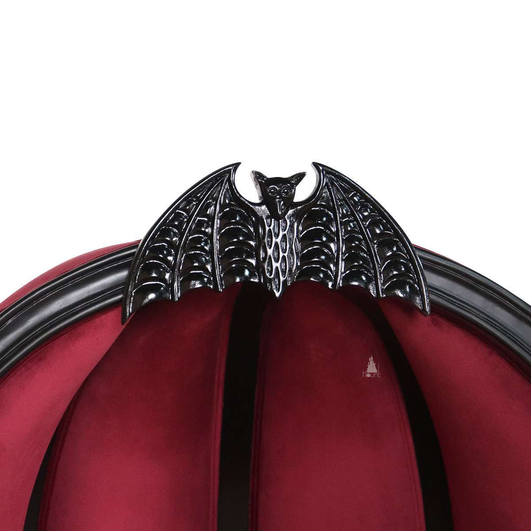 Another view of the Queen of the Damned Porter Chair, a tall hooded chair with deep red upholstery and a bat crest