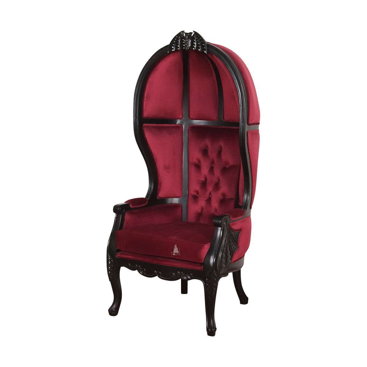 Another view of the Queen of the Damned Porter Chair, a tall hooded chair with deep red upholstery and a bat crest
