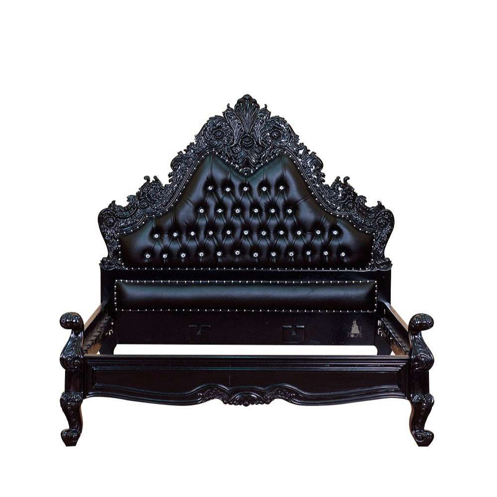 The Seduce Bedazzled Bed, a handcrafted gothic bed with ornate carved cresting, diamond-tufted upholstery and a low shaped footboard.