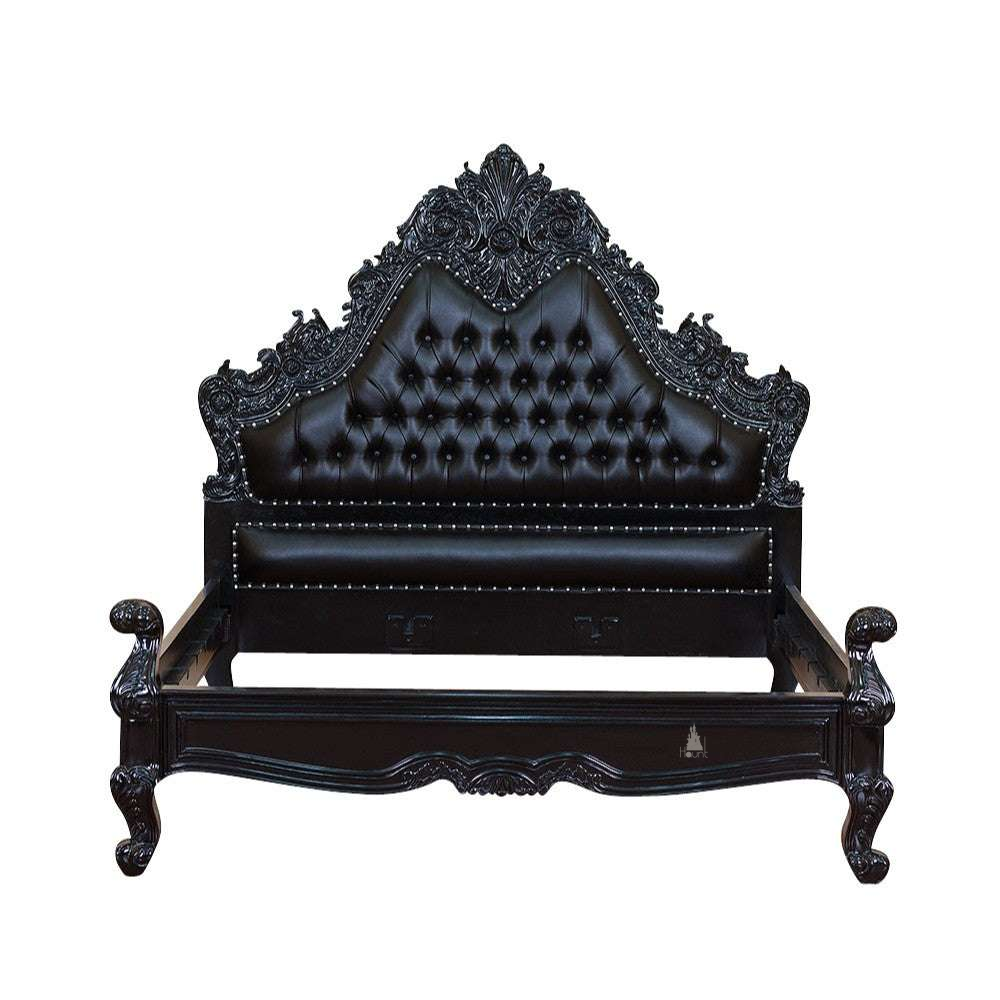 The Seduce Bedazzled Bed, a handcrafted gothic bed with ornate carved cresting, diamond-tufted upholstery and a low shaped footboard.