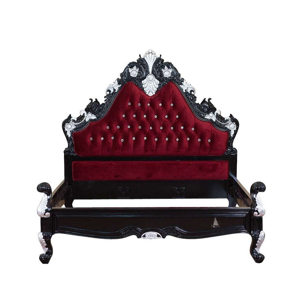 The Seduce Bedazzled Bed, a handcrafted gothic bed with ornate carved cresting, diamond-tufted upholstery and a low shaped footboard.