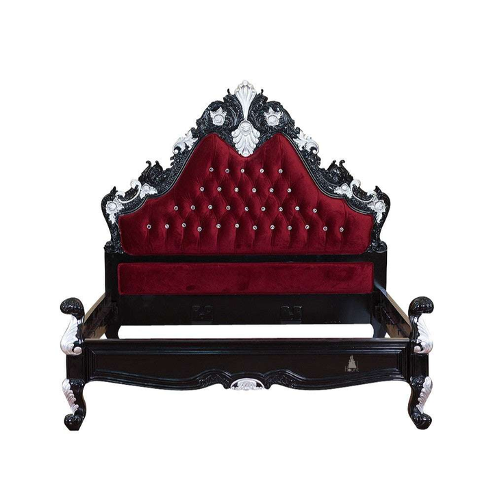 The Seduce Bedazzled Bed, a handcrafted gothic bed with ornate carved cresting, diamond-tufted upholstery and a low shaped footboard.