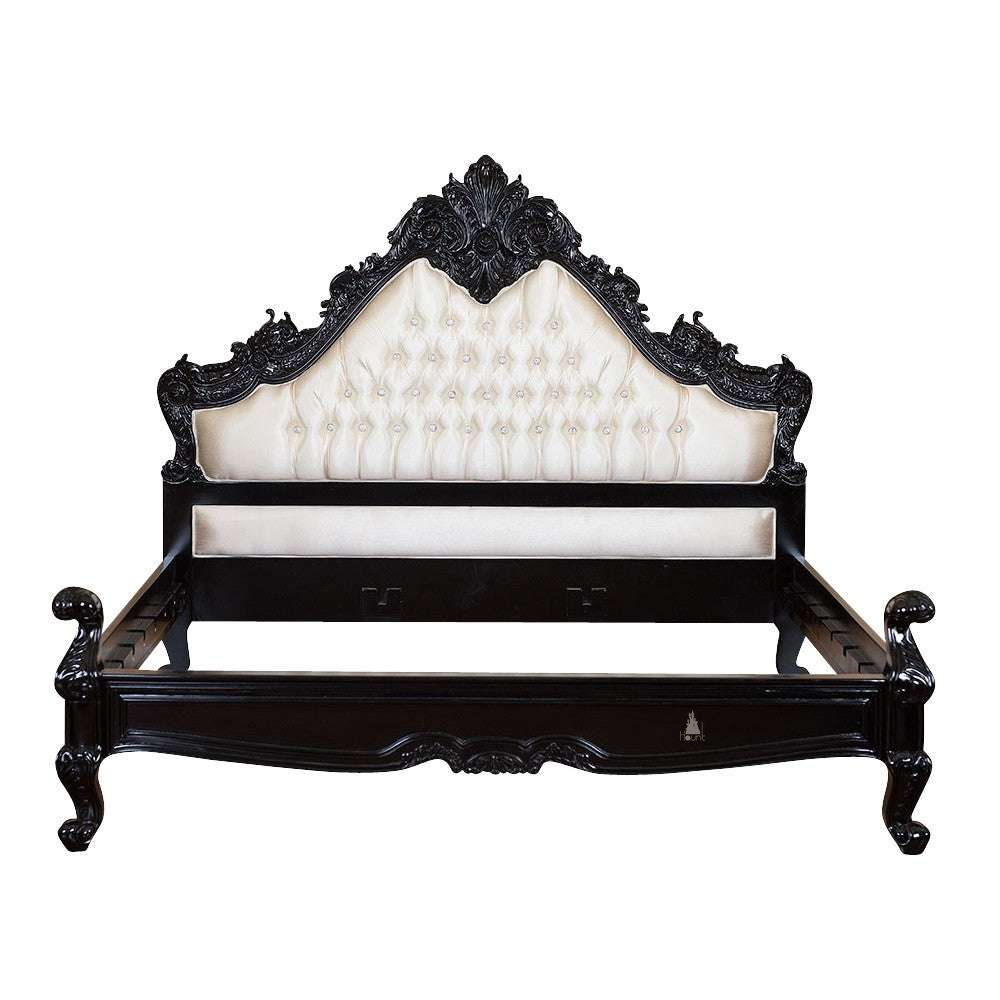 The Seduce Bedazzled Bed, a handcrafted gothic bed with ornate carved cresting, diamond-tufted upholstery and a low shaped footboard.