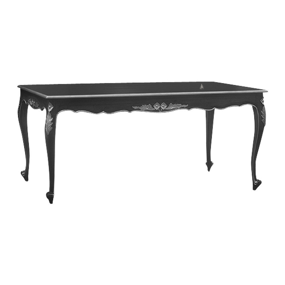 The Seduce Dining Table, a handcrafted black gothic dining table with decorative silver detailing and elegant tapered legs.